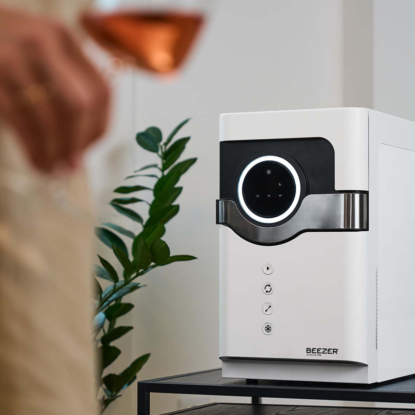 A picture of the white BEEZER drinks cooler standing on a table.