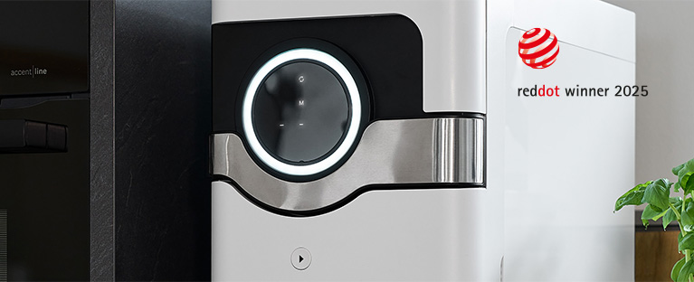 A picture of a white BEEZER beverage cooler, switched on in a kitchen, and a reddot winner 2025 award.