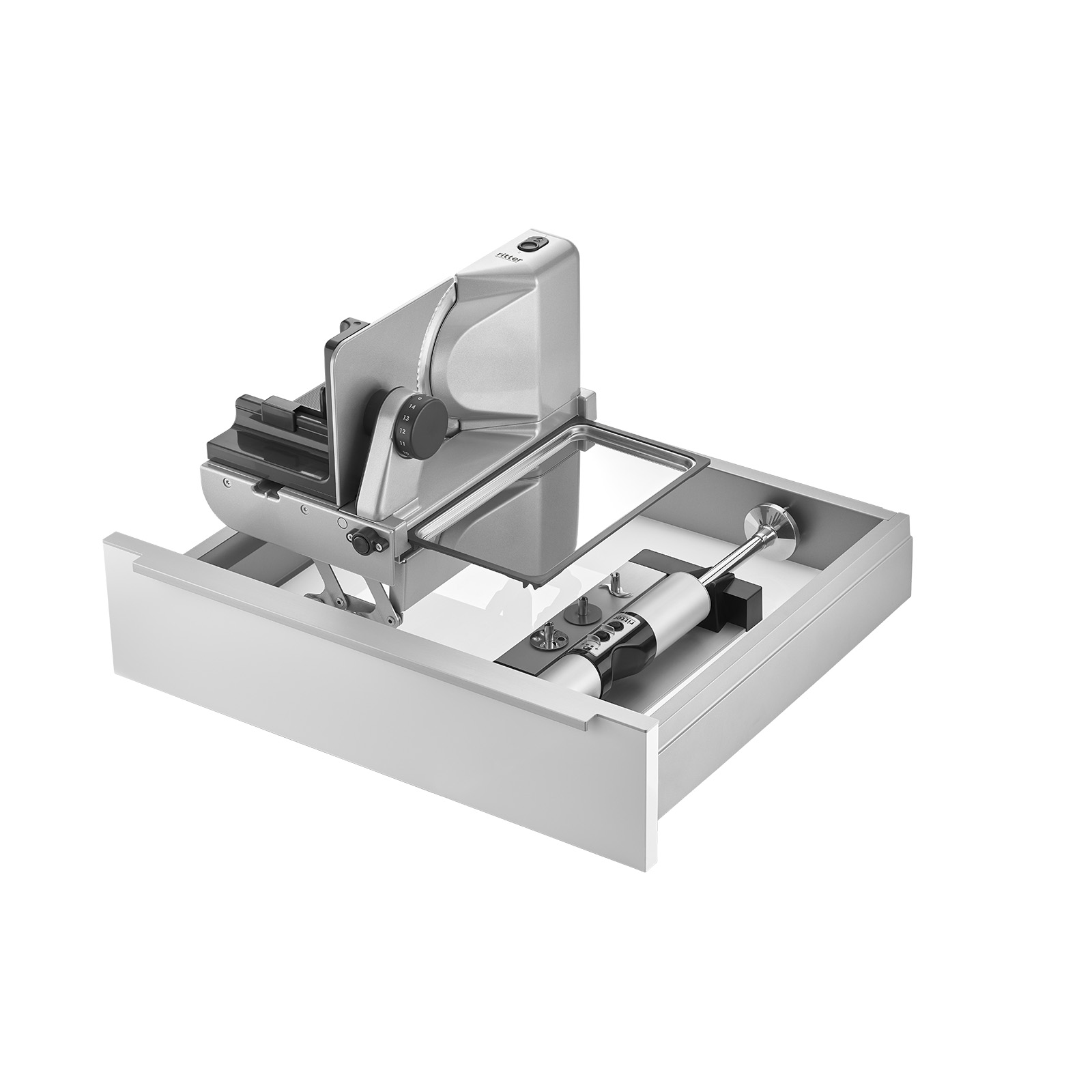 Ein Bild einer Schublade, mit einer Einbau-Kombination aus einem Einbau-Stabmixer und einem linksgeführten und aufgestellten Einbau-Allesschneider, mit weißem Hintergrund.