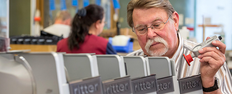 A picture of a man assembling all-purpose slicers.