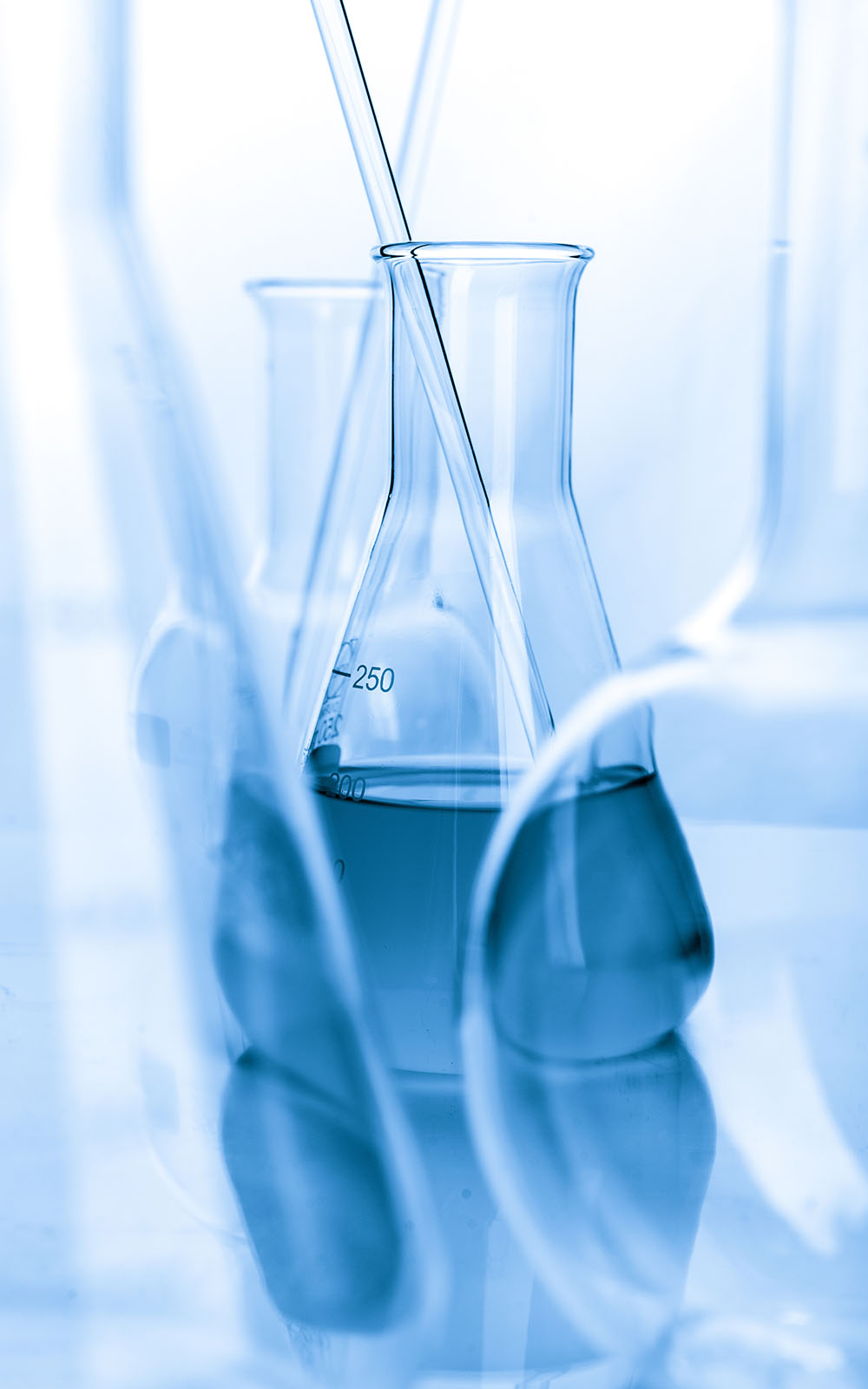 Blue laboratory containers and glassware against a light background.