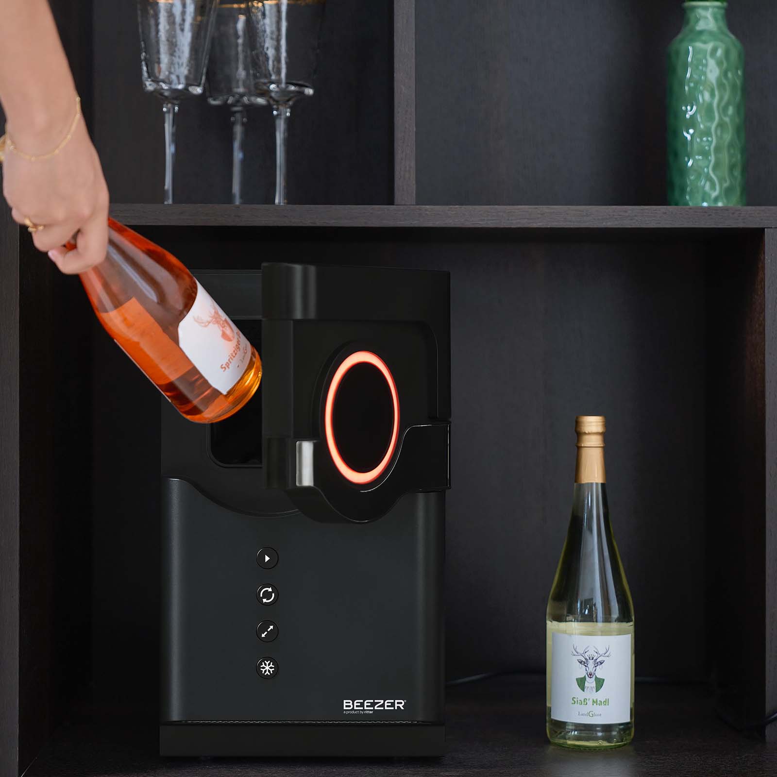 A picture of the black BEEZER drinks cooler, with a wine bottle placed in the BEEZER.