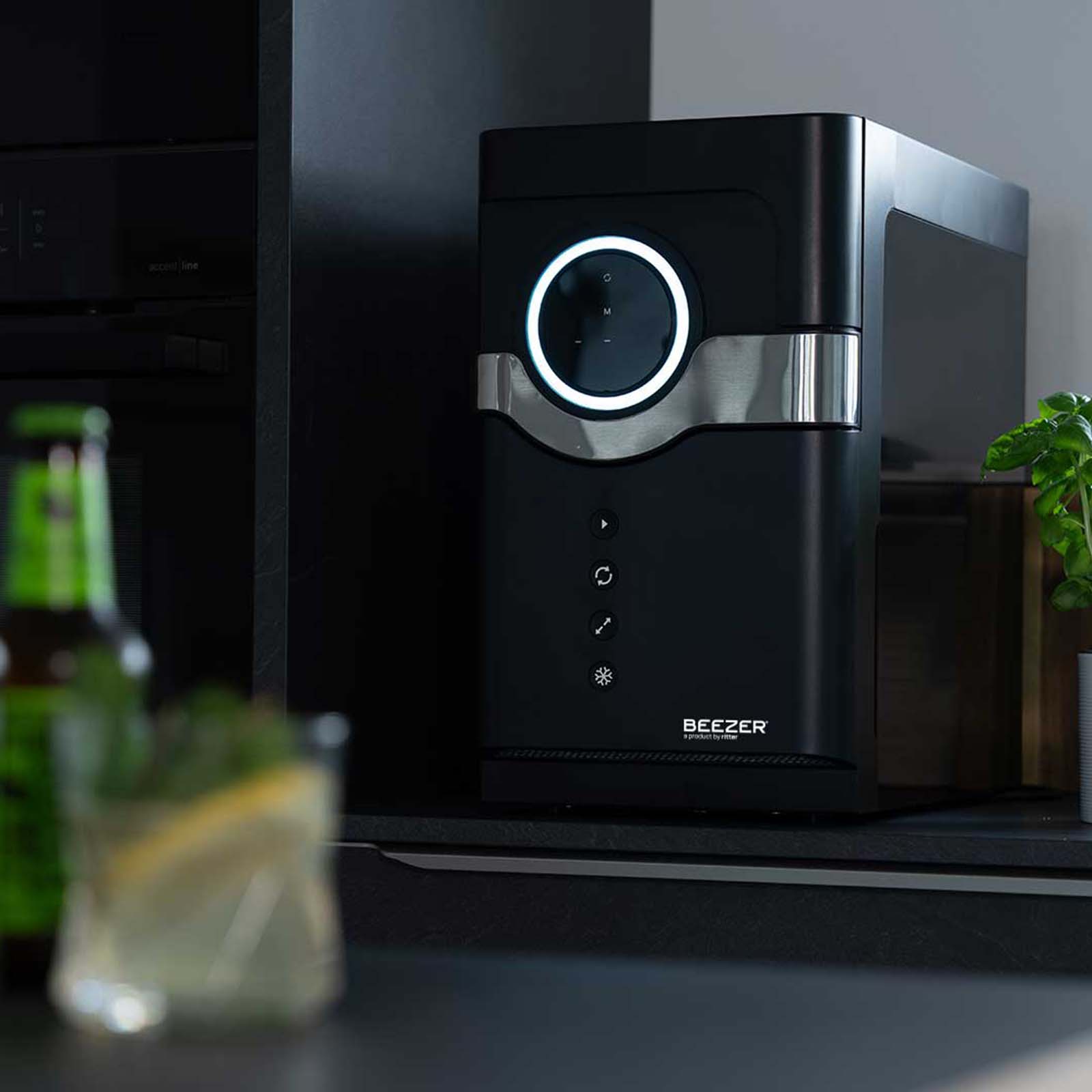 A picture of the black BEEZER drinks cooler switched off in a kitchen.