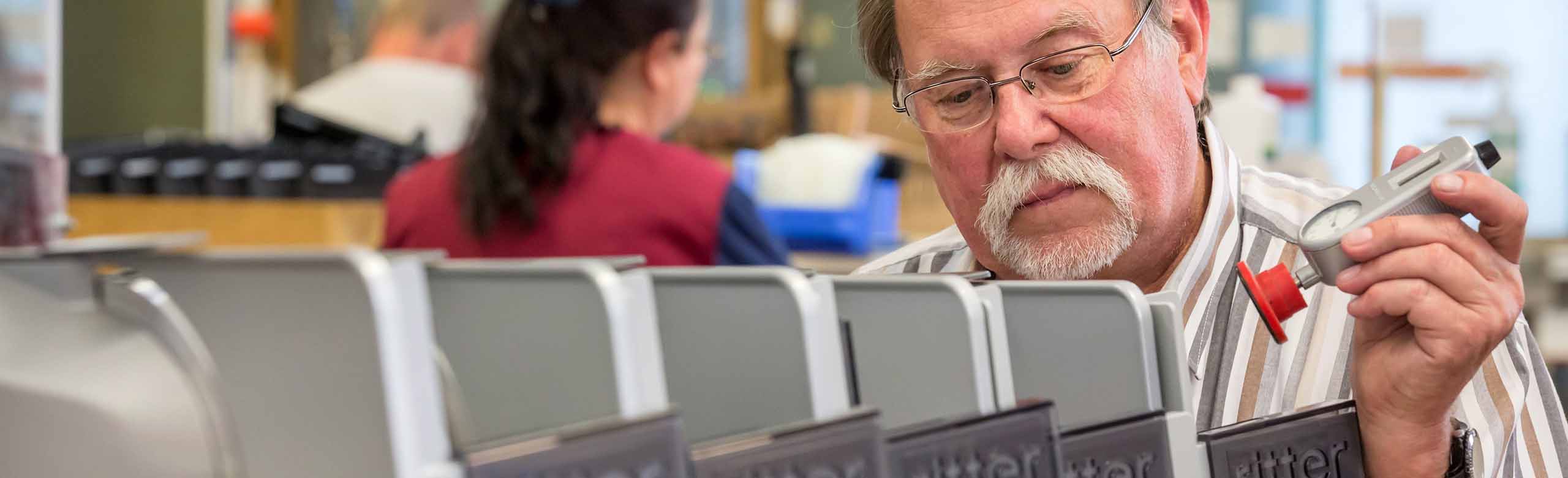 A picture of a man assembling all-purpose slicers.