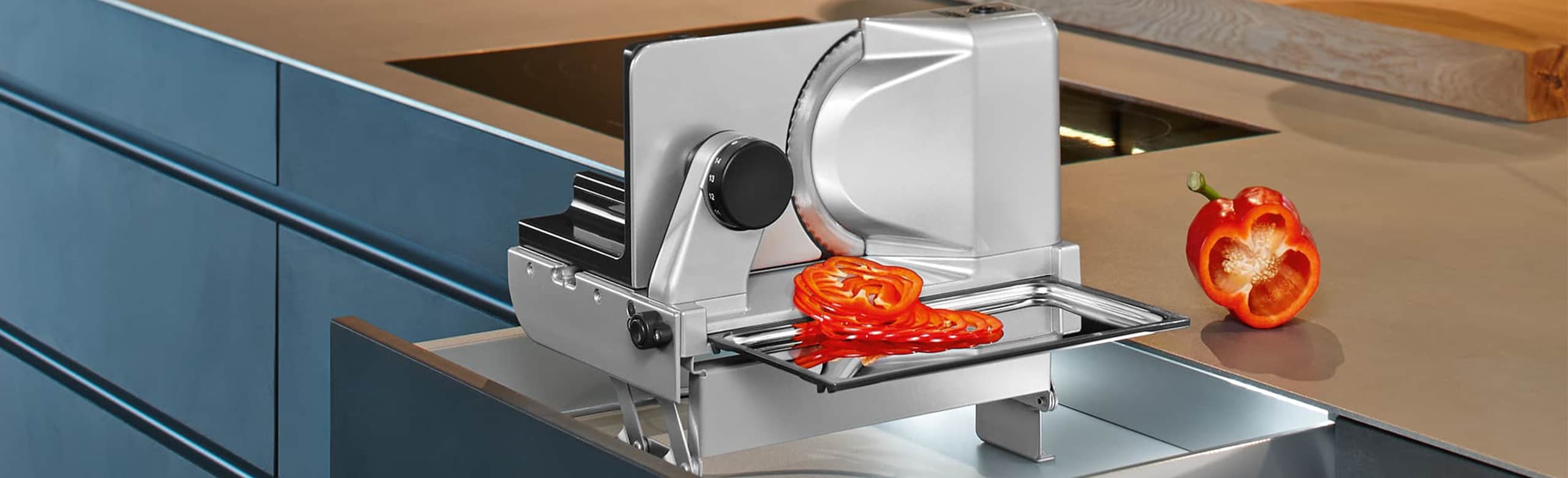 Built-in food slicer in modern kitchen with sliced food
