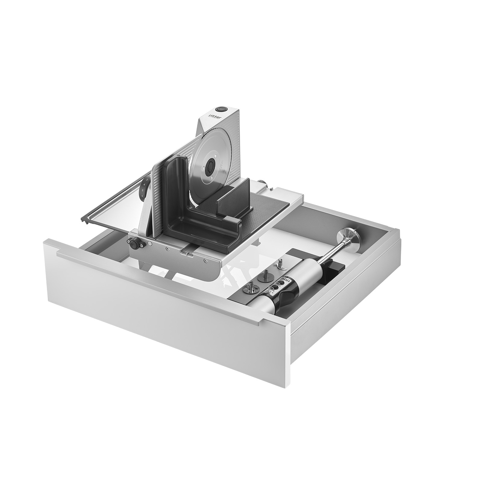 Ein Bild einer Schublade, mit einer Einbau-Kombination aus einem Einbau-Stabmixer und einem rechtsgeführten und aufgestellten Einbau-Allesschneider, mit weißem Hintergrund.