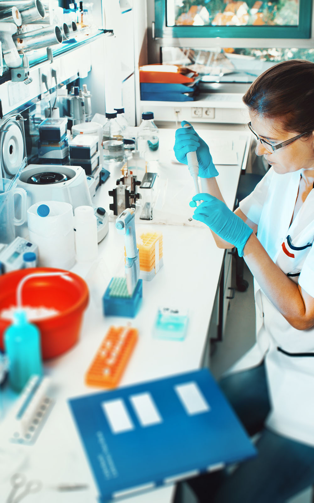 Laboratory staff working with chemical substances and laboratory equipment.